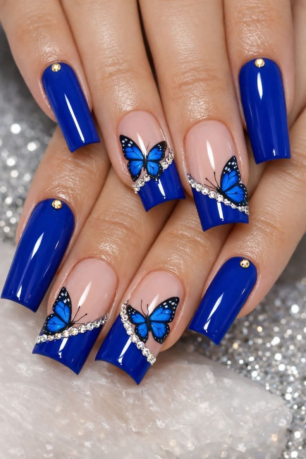 Unhas azuis com borboletas e cristais